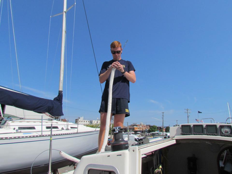 Colin Caraher prepping one of the Avenger's safety lines at Desmond Marine on July 10, 2023.