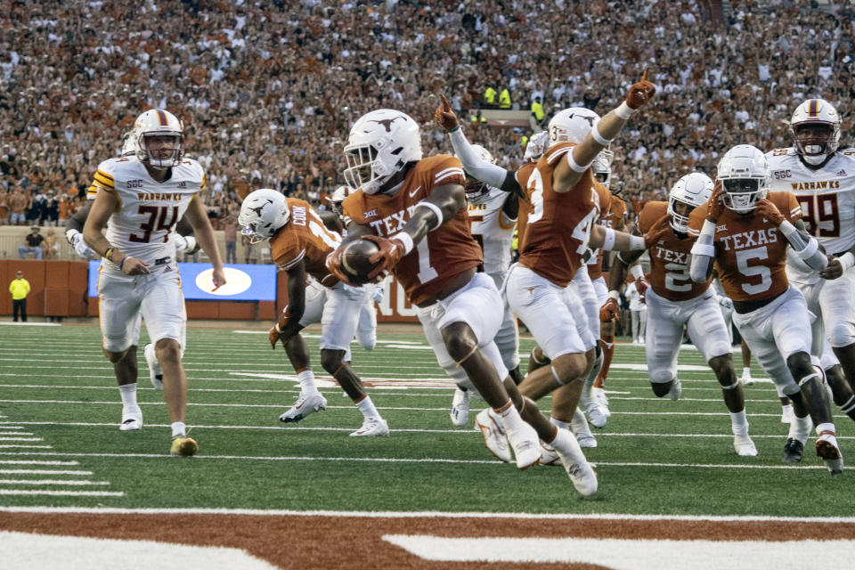 Texas running back Keilan Robinson (7) scores a touchdown after picking up the punt he blocked during an NCAA college football game against Louisiana-Monroe, Saturday, Sept. 3, 2022, in Austin, Texas. (AP Photo/Michael Thomas)