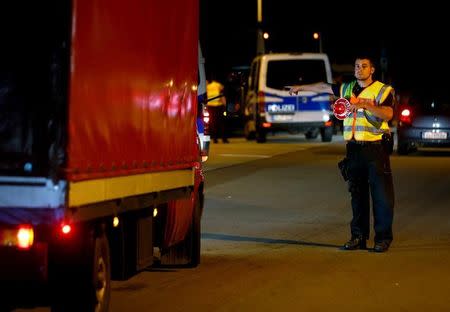 German policemen check vehicles on the highway A3 from Austria to Germany at the Parking in Rottal Ost near Passau, southern Germany September 14, 2015. REUTERS/Michael Dalder