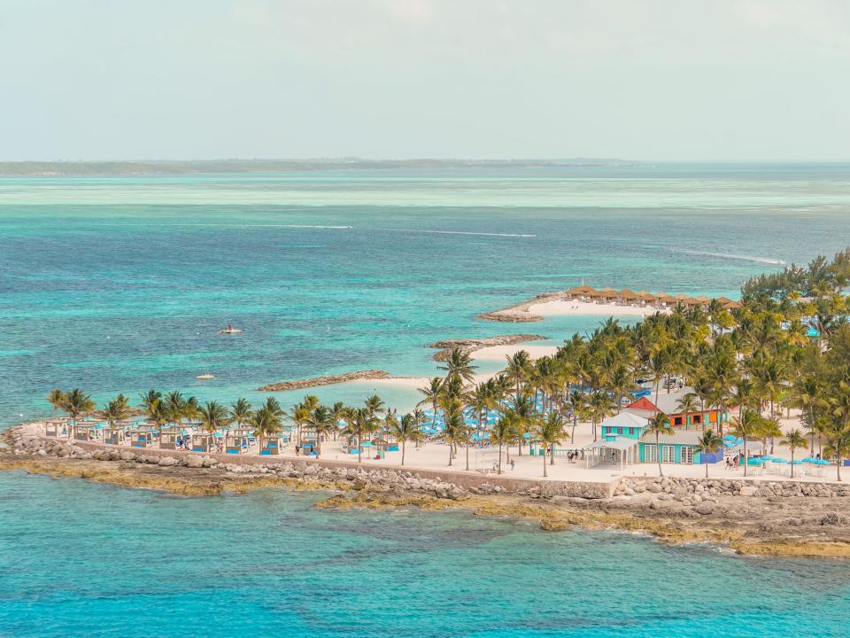 The edge of CocoCay seen from above with clear ocean waters in the foreground and background