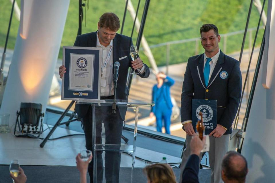 Niccolo Starace, CEO of Russell Stover Chocolates, left, accepts the Guinness World Record award for the largest box of chocolate at Kauffman Center for the Performing Arts on Monday, April 17, 2023, in Kansas City. The oversized 5,616 pound replica of the brand’s chocolate box was filled with specialty chocolates weighing from 11 to 38 pounds each.