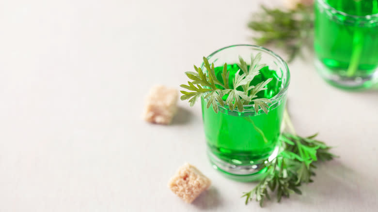 Absinthe garnished with anise leaves and sugar cubes