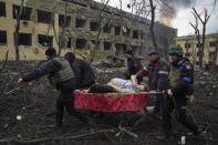 FILE - Ukrainian emergency employees and police officers evacuate injured pregnant woman Iryna Kalinina, 32, from a maternity hospital that was damaged by a Russian airstrike in Mariupol, Ukraine, March 9, 2022. The award-winning film "20 Days in Mariupol" got its premiere in Ukraine on Saturday, June 3, 2023, attended by some Ukrainian medics and security officials who got their first look at the jarring documentary on how Russian forces bombed and blasted their way into the southeastern port city last year. (AP Photo/Evgeniy Maloletka, File)