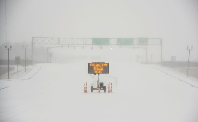 A sign warns motorists after a sudden heavy bout of snow and frozen rain on MS Highway 463 in Madison