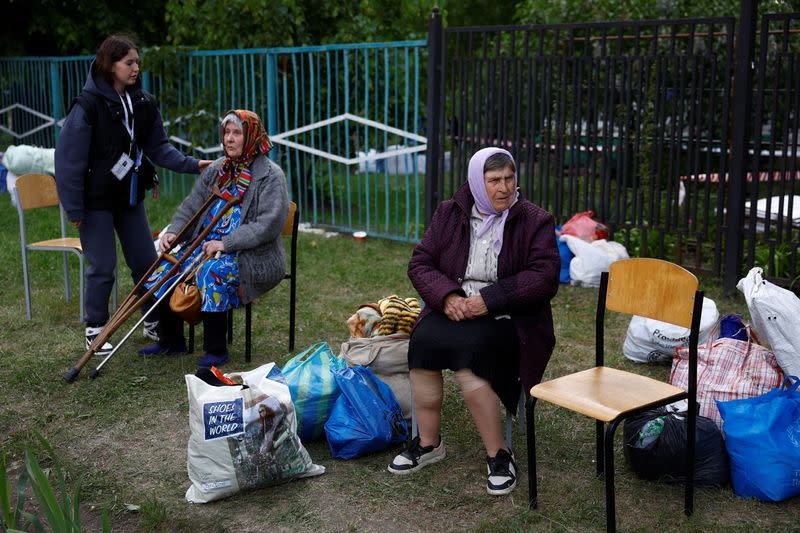 Vovchansk area residents, who fled due to Russian military strikes, wait at an evacuation centre compound in Kharkiv region