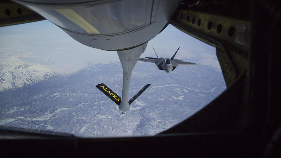FILE - In this photo provided by the Alaska National Guard, an F-22 Raptor jet fighter prepares to hook up to an Alaska Air National Guard KC-135 Stratotanker, from the 168th Air Refueling Wing, to conduct in-air refueling over the Joint Pacific Alaska Range Complex during their fighter/bomber exercises May 1, 2014. The Air National Guard has delayed personnel changes in Alaska until Sept. 2025, that could have threatened national security and civilian rescue missions. (Lt. Bernie Kale/Alaska National Guard via AP, File)