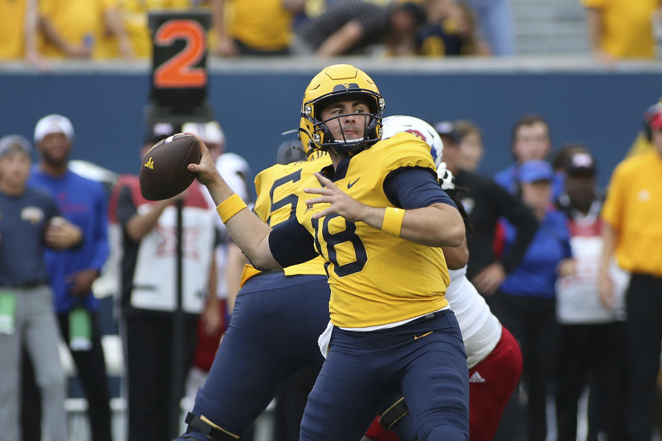 West Virginia quarterback JT Daniels passes against Kansas during the first half of an NCAA college football game in Morgantown, W.Va., Saturday, Sept. 10, 2022. (AP Photo/Kathleen Batten)