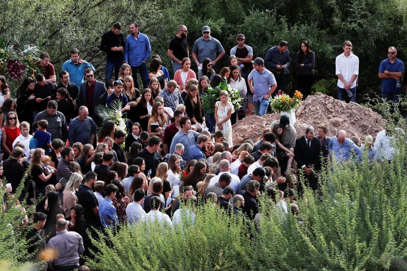 Relatives bury Dawna Ray Langford and her sons Trevor and Rogan, who were killed by unknown assailants, in La Mora