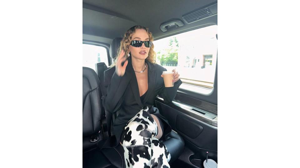 Rita Ora wearing cow-print thigh-high boots