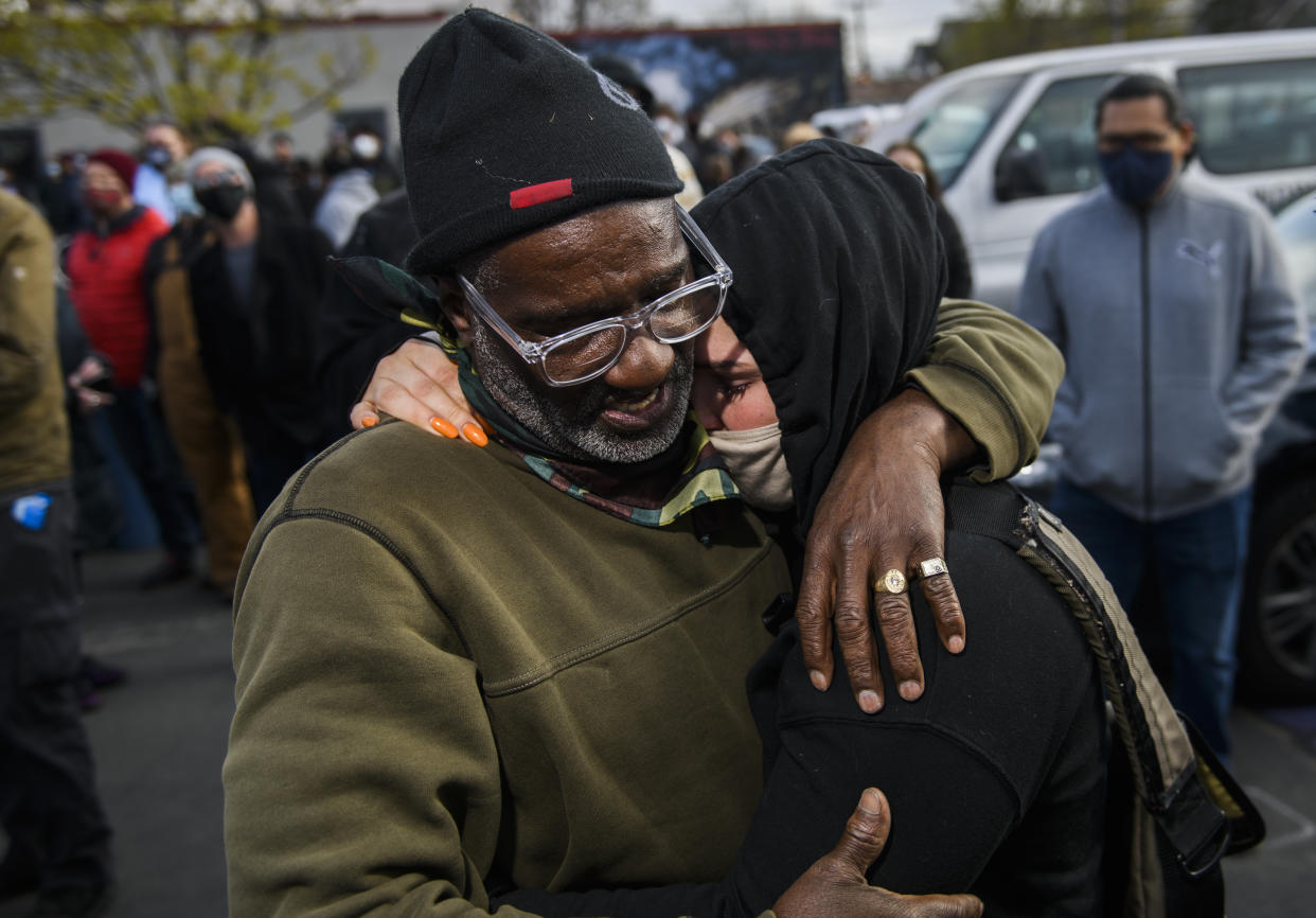 Charles McMillan (L) and Genevieve Hansen, witnesses who testified in the trial, embrace in George Floyd Square after the verdict was read in the Derek Chauvin trial.