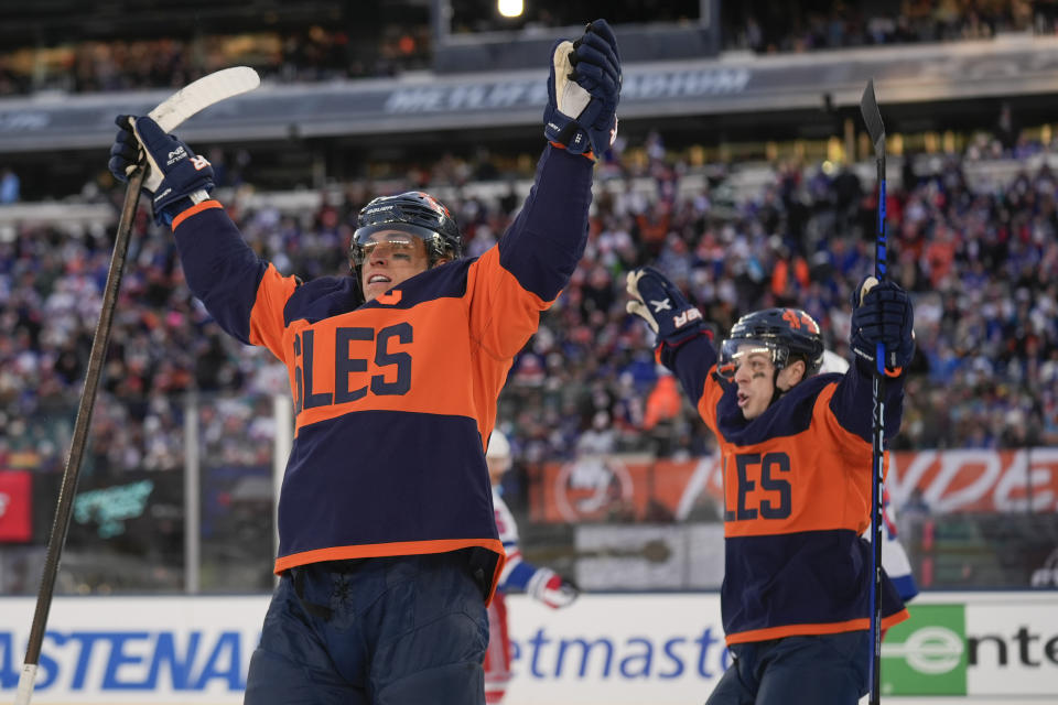 New York Islanders' Anders Lee, left, reacts after scoring during the second period of an NHL Stadium Series hockey game against the New York Rangers in East Rutherford, N.J., Sunday, Feb. 18, 2024. (AP Photo/Seth Wenig)