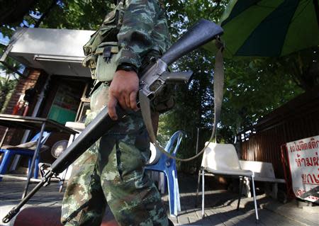 A Thai soldier walks in front of the National Broadcasting Services of Thailand television station in Bangkok May 20, 2014. REUTERS/Athit Perawongmetha