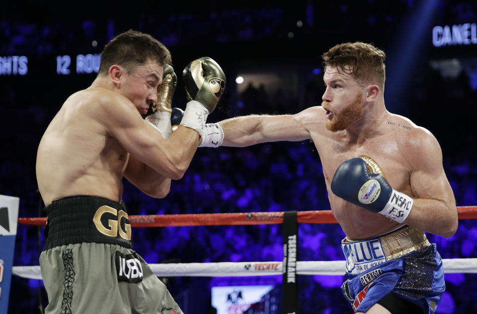 Canelo Alvarez, right, throws a right at Gennady Golovkin during their fight in Las Vegas on Saturday. (AP)