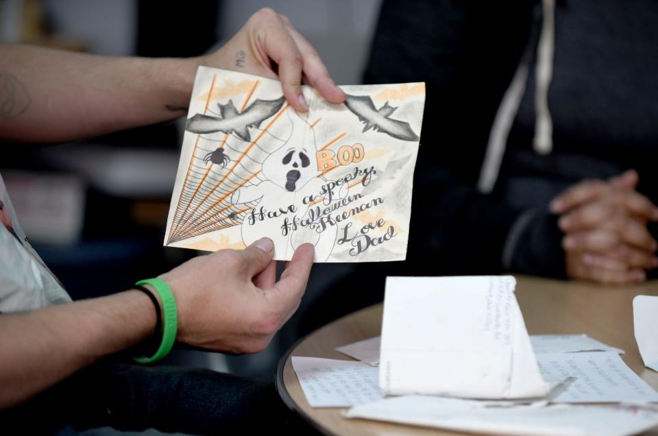 Keenan Walker shares a card from his father David McKain, who took his own life at the Stark County Jail last year.