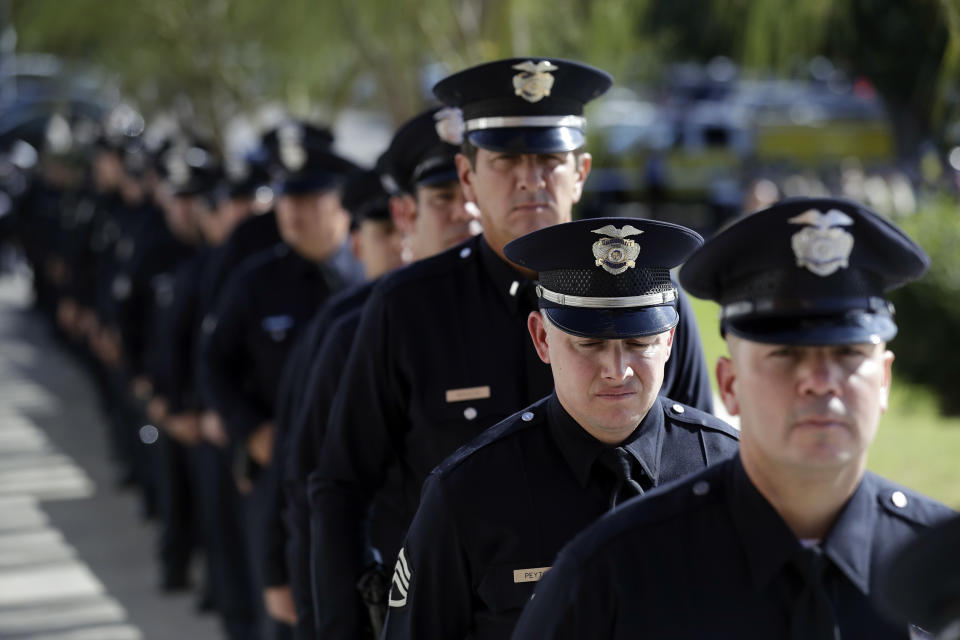 Law enforcement personnel wait to enter the Calvary Community Church for a service in memory of Ventura County Sheriff's Sgt. Ron Helus at Thursday, Nov. 15, 2018, in Westlake Village, Calif. Helus was fatally shot while responding to a mass shooting at a country music bar in Southern California. (AP Photo/Marcio Jose Sanchez, Pool)