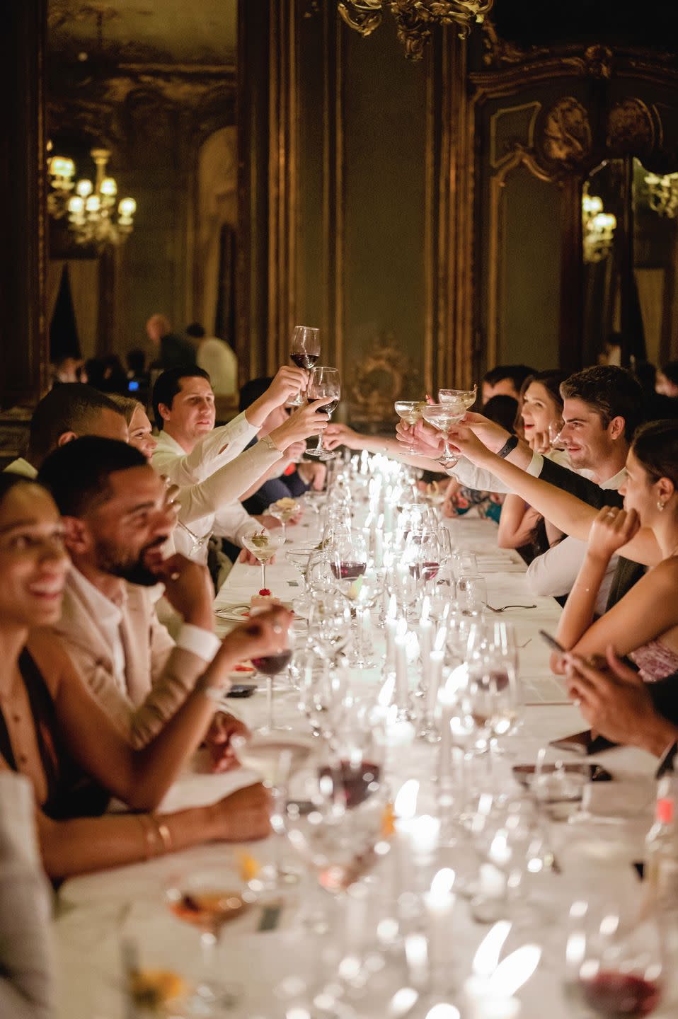 a group of people sitting around a table with wine glasses