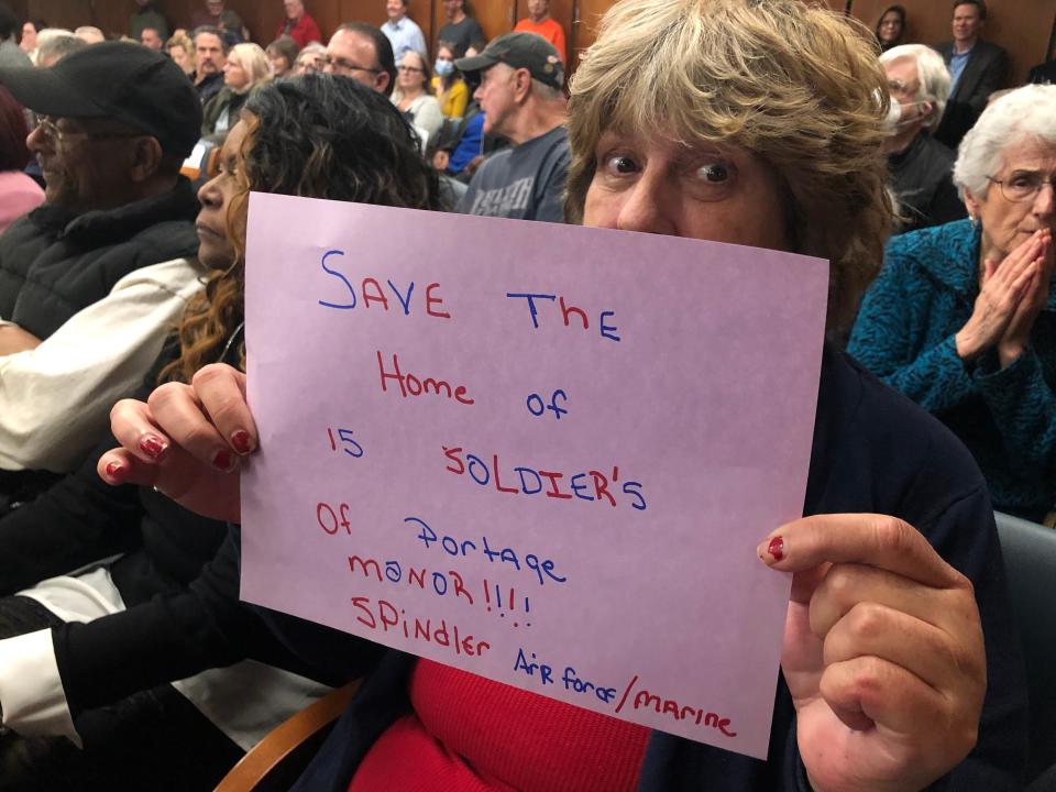 Portage Manor residents hold signs of support at the St. Joseph County Council meeting on Tuesday, March 14, 2023.