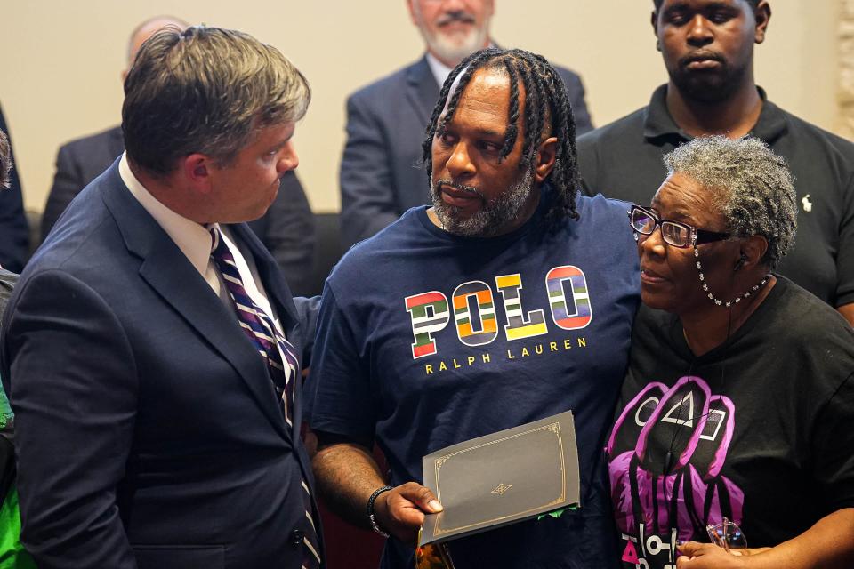 Cedar Park Mayor Jim Penniman-Morin, left, presents Anthony Hill, center, and Carolyn Hartman, right, with the proclamation recognizing June as Pride Month at Thursday's Cedar Park City Council meeting.