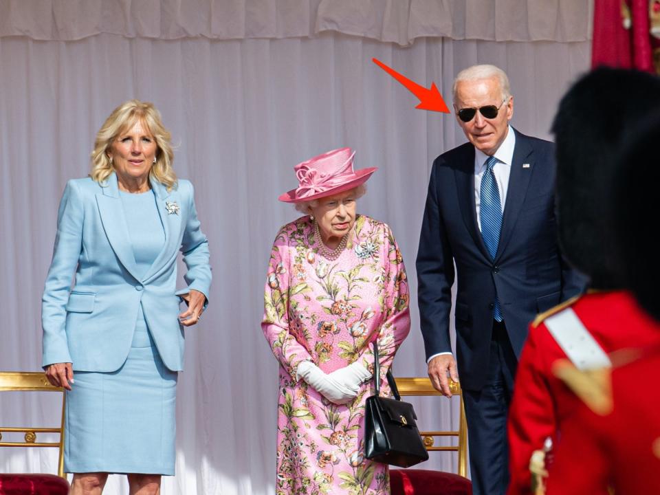 Jill Biden, Queen Elizabeth II, and Joe Biden stand on a stage together on June 13, 2021.