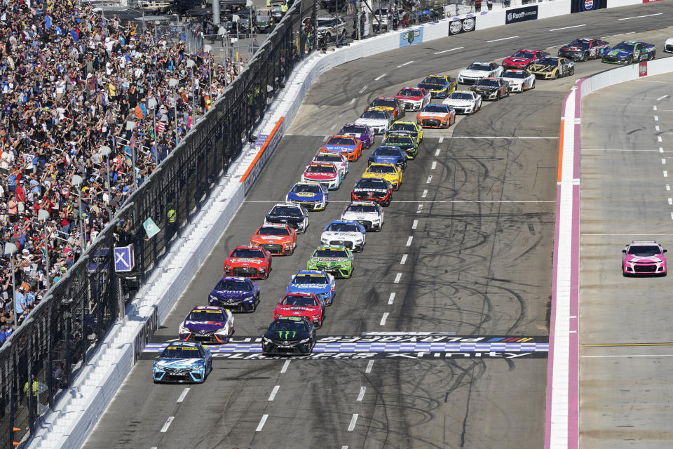 Martin Truex Jr. (19) leads the field at the start of a NASCAR Cup Series auto race at Martinsville Speedway in Martinsville, Va., Sunday, Oct. 29, 2023. (AP Photo/Chuck Burton)