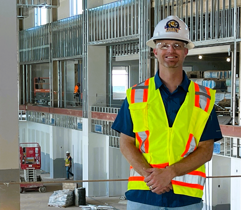 Dr. Cody Blair, principal of Wichita Falls Legacy High School, stands in his new workplace as it's being built.