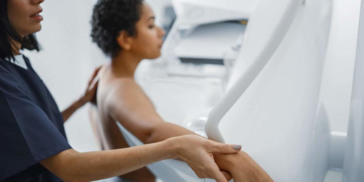 female doctor helping patient with mammogram procedure - mammograms at 40