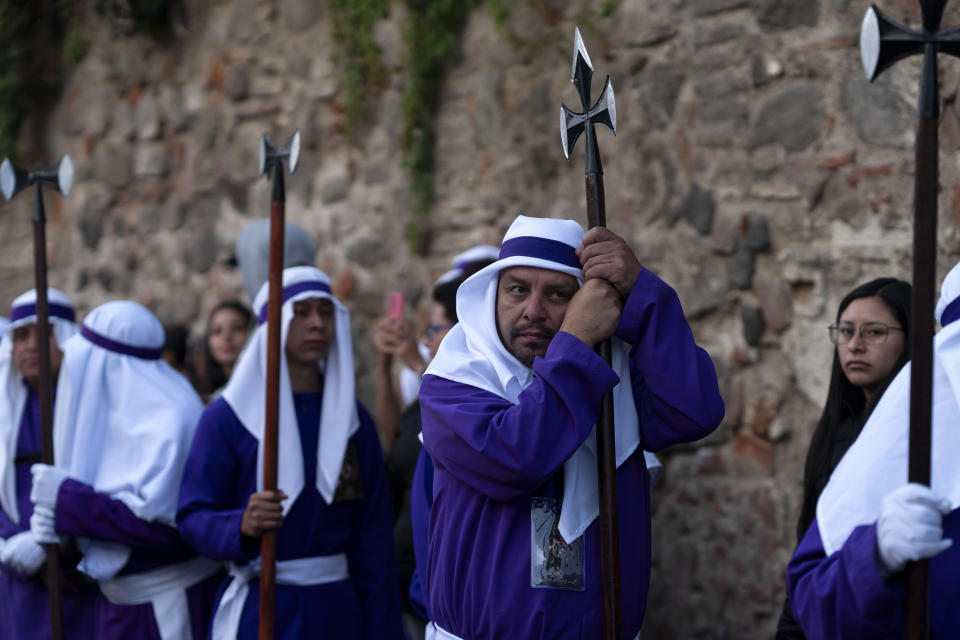 Penitents knows as cucuruchos wait their turn to take part in a Holy Week procession in Antigua, Guatemala, on Good Friday, March 29, 2024. (AP Photo/Moises Castillo)