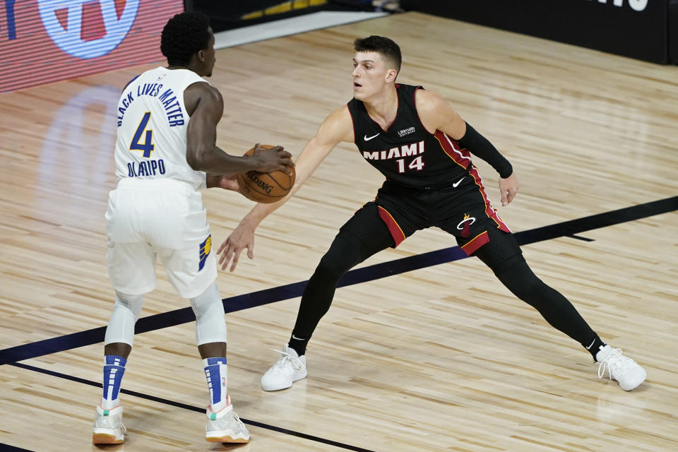 Miami Heat's Tyler Herro (14) guards Indiana Pacers' Victor Oladipo (4) during the first half of an NBA basketball first round playoff game Monday, Aug. 24, 2020, in Lake Buena Vista, Fla. (AP Photo/Ashley Landis, Pool)