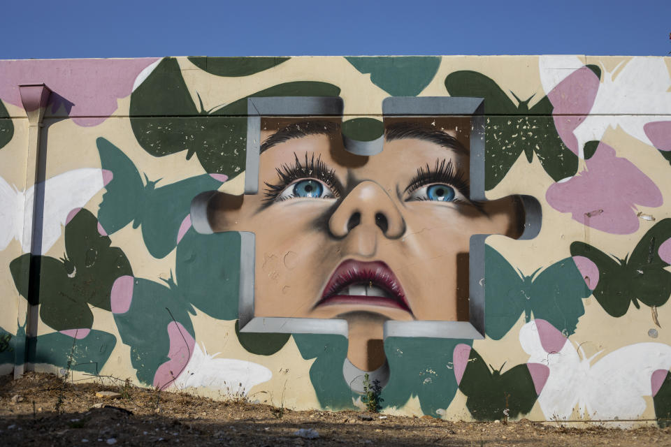 A concrete bomb shelter is decorated with artwork, in Sderot, Israel, Tuesday, July 20, 2021. No place in Israel has been hit harder by Palestinian rocket fire than Sderot, a working-class town just about a mile (1.5 kilometers) from the Gaza border. Although Sderot is enjoying an economic boom and revival, a generation of children and parents are suffering from the traumatic effects of two decades of rocket fire that experts are still struggling to understand. (AP Photo/Ariel Schalit)