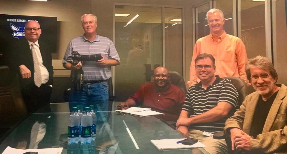 In a photo taken by Charlotte Hornets owner Michael Jordan before an interview, Charlotte Observer staffers smile from an office in the Spectrum Center in 2014. From left, standing: Hornets beat writer Rick Bonnell, photographer Jeff Siner and sports columnist Scott Fowler. Seated, from left: sports editors Harry Pickett, Mike Persinger and Gary Schwab.