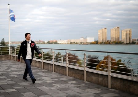 Liberal leader and Canadian Prime Minister Justin Trudeau walks with the city skyline of Detroit in the United States in the background, during an election campaign visit to Windsor
