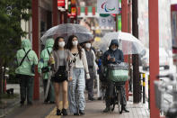 People wearing face masks to help curb the spread of the coronavirus walk around in the famed Asakusa shopping area on a rainy day in Tokyo on Thursday, May 27, 2021. (AP Photo/Hiro Komae)