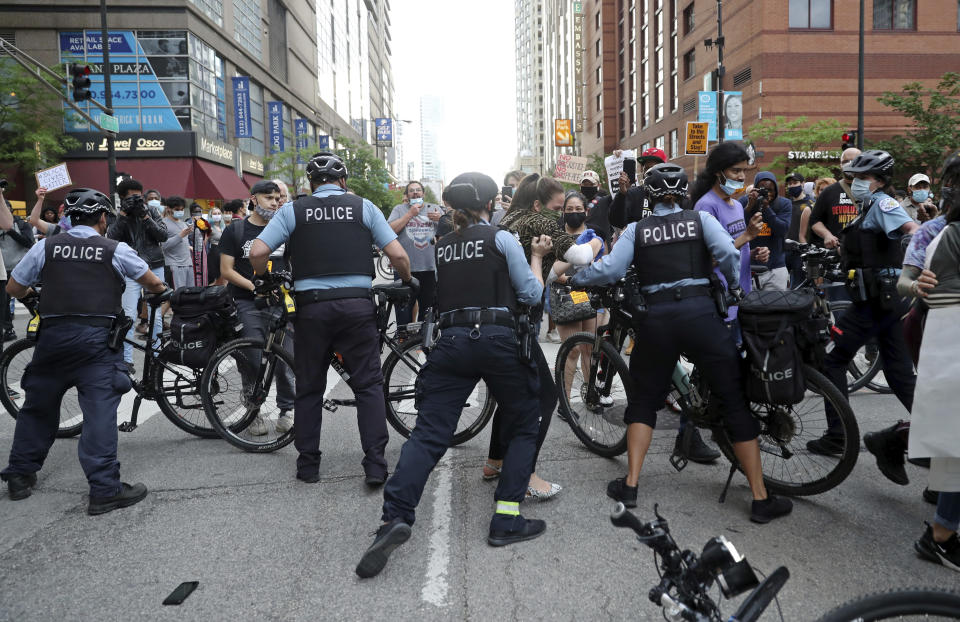 Protesters attempt to break through a police barrier during a march to bring attention to the death of George Floyd in the Loop Friday, May 29, 2020, in Chicago. Floyd died after being restrained by Minneapolis police officers on Memorial Day. (John J. Kim/Chicago Tribune via AP)