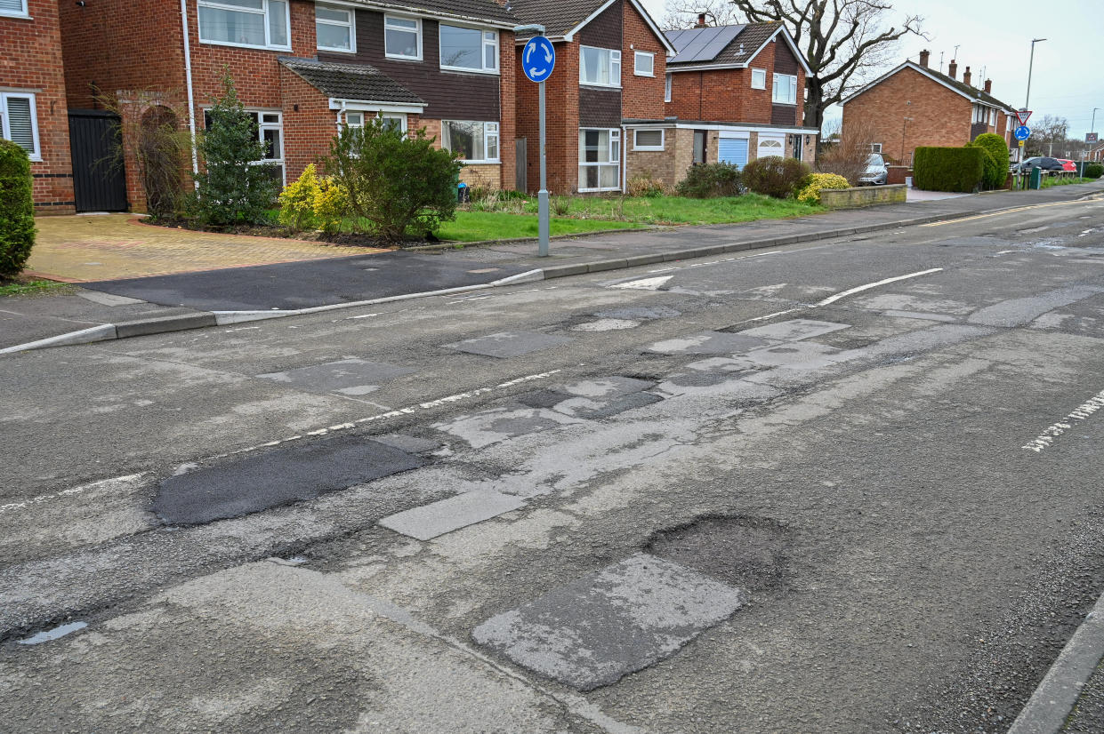 Residents of Caernarvon Road in Cheltenham are furious at council after certain roads are repaved but this one. February 23 2024. See SWNS story SWLNpothole. Residents are baffled after the council could 'only afford' to repair a tiny 230m stretch of their pothole-filled road - leaving most of it full of holes. This week workers visited Caernarvon Road in Cheltenham, Gloucestershire, after weeks of complaints from residents over the state of the road. But they only filled in huge potholes on a small stretch - leaving the remaining 500m filled with 50cm potholes. Residents claim the council told they they only had enough cash in the kitty to fill in the tiny stretch.