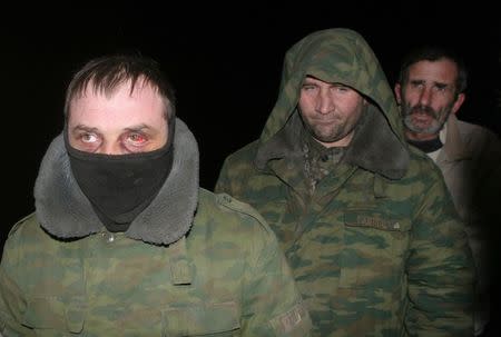 Ukrainian prisoners of war get ready to be exchanged for members of pro-Russian separatists near the village of Zholobok in Luhansk region, eastern Ukraine, February 21, 2015. REUTERS/Igor Tkachenko