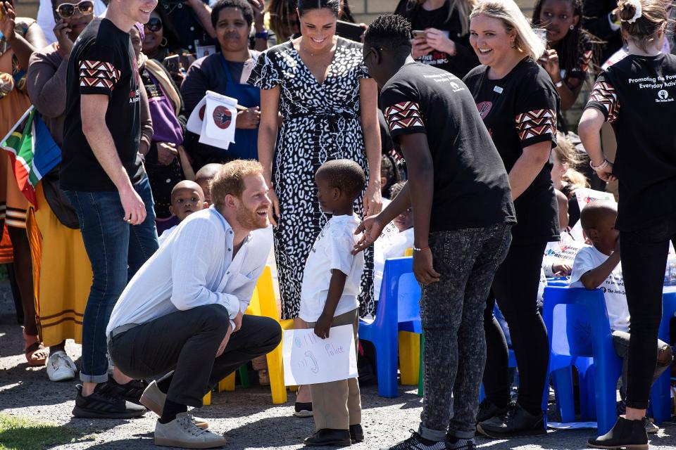 Prince Harry opted for a white linen shirt, grey chinos and grey trainers to visit the township of Nyanga in Cape Town [Photo: Getty Images]