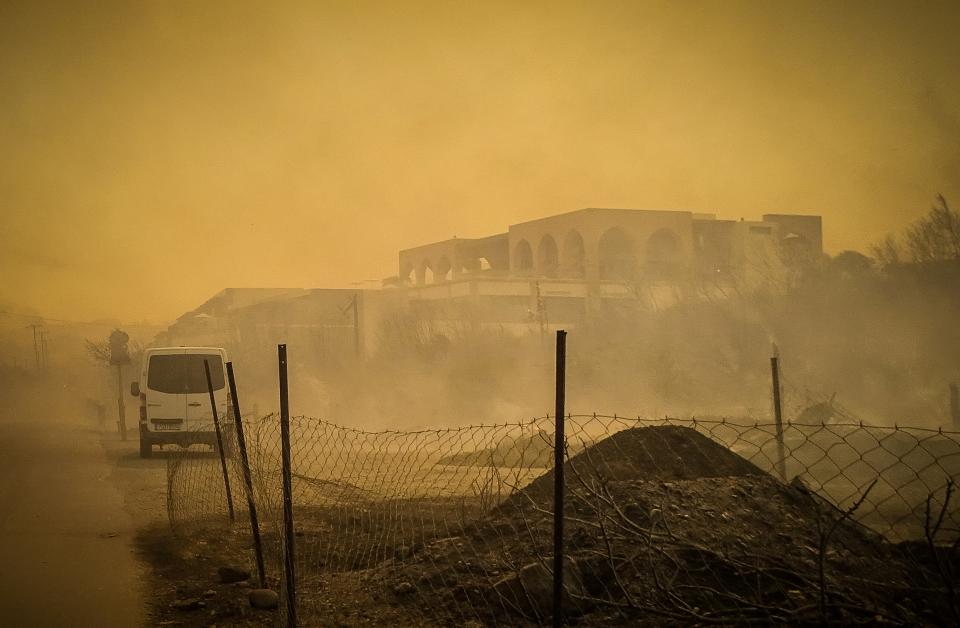 A burnt hotel is seen during a wildfire on the island (via REUTERS)