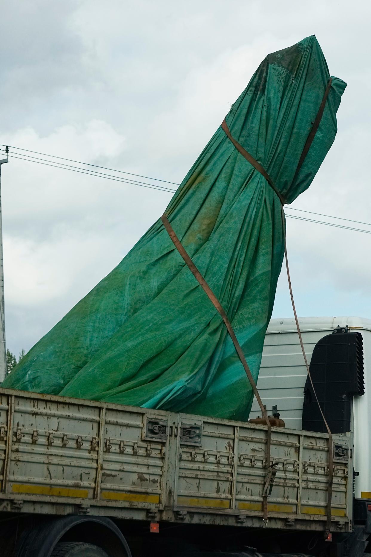 A truck carries a part of a private jet that crashed near the village of Kuzhenkino, Tver region, Russia (AP)