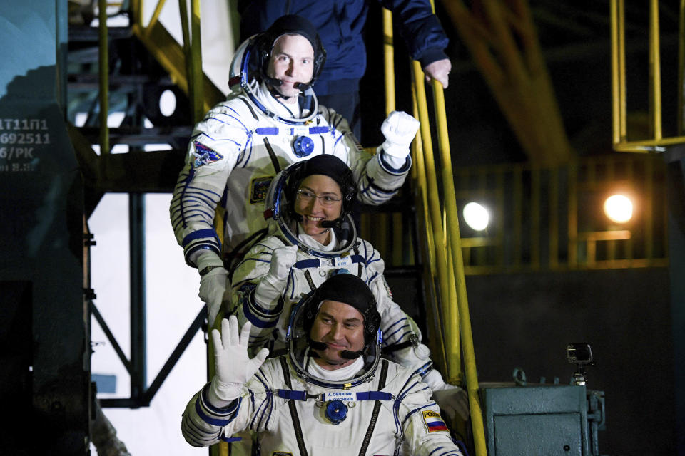 U.S. astronauts Christina Hammock Koch, centre, Nick Hague, above, and Russian cosmonaut Alexey Ovchinin, crew members of the mission to the International Space Station, ISS, wave as they board to the rocket prior the launch of Soyuz-FG rocket at the Russian leased Baikonur cosmodrome, Kazakhstan, Thursday, March 14, 2019. (AP Photo/Kyrill Kudryavtsev, Pool)