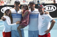 Bob Bryan of the U.S. second left, is embraced by his wife Michelle Alvarez, left, and daughter Micael as he poses with his brother Mike and coach David Macpherson following their third round doubles loss to Croatia's Ivan Dodig and Slovakia's Filip Polasek at the Australian Open tennis championship in Melbourne, Australia, Monday, Jan. 27, 2020. (AP Photo/Dita Alangkara)