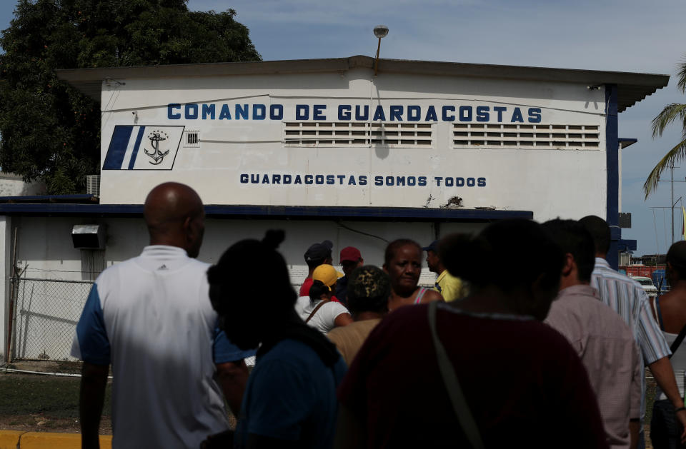 Relatives of the people who disappeared in the Caribbean Sea after boarding a smuggler's boat during an attempt to cross from Venezuela to Trinidad and Tobago, gather outside the coast guard building in Guiria, Venezuela, on May 23. (Photo: Ivan Alvarado/Reuters)