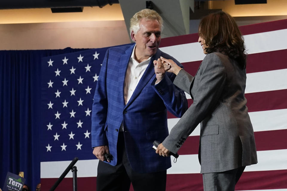 Vice President Kamala Harris, right, gives a fist bump with Democratic gubernatorial candidate former Gov. Terry McAuliffe during a rally in Norfolk, Va., Friday, Oct. 29, 2021. McAuliffe will face Republican Glenn Youngkin in the November election. (AP Photo/Steve Helber)