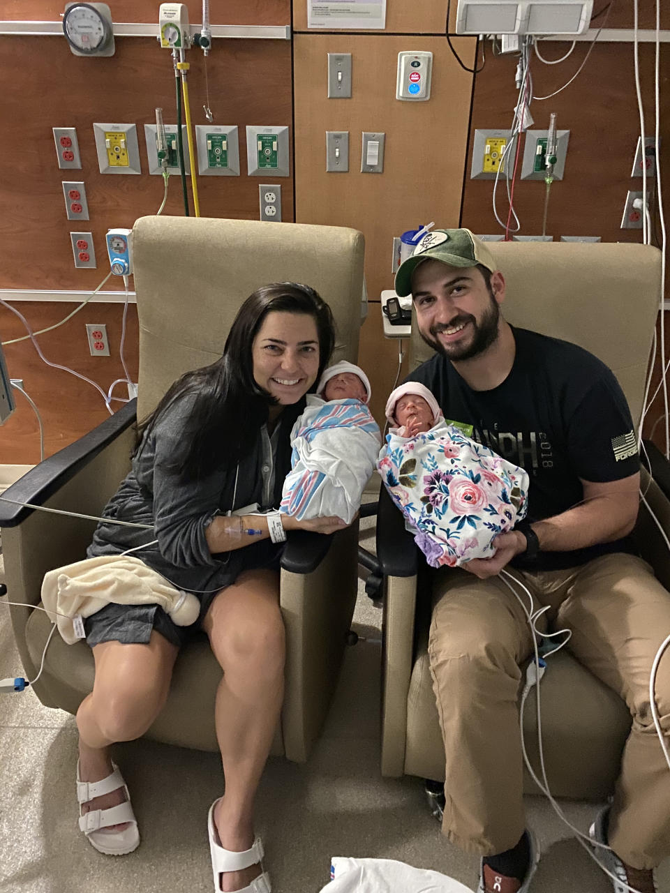 Erin and Jake Credo cuddled up with their identical twin daughters, Lola and Allie.  (Erin Credo)