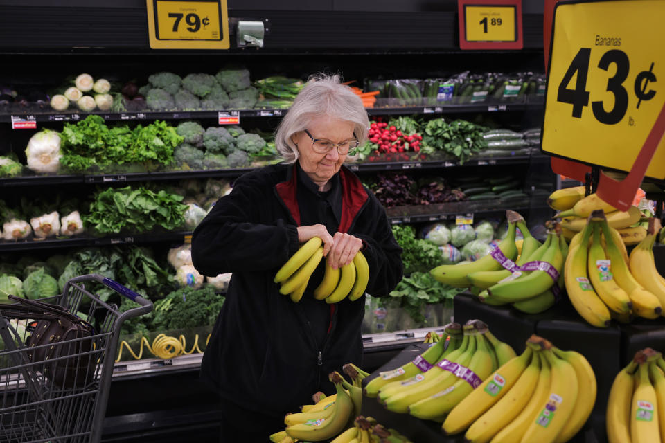 Pauline Doty picks bananas to add to the ones in her cart at a Food Lion in Columbia, SC., on Jan. 27, 2023. (Travis Dove for NBC News)