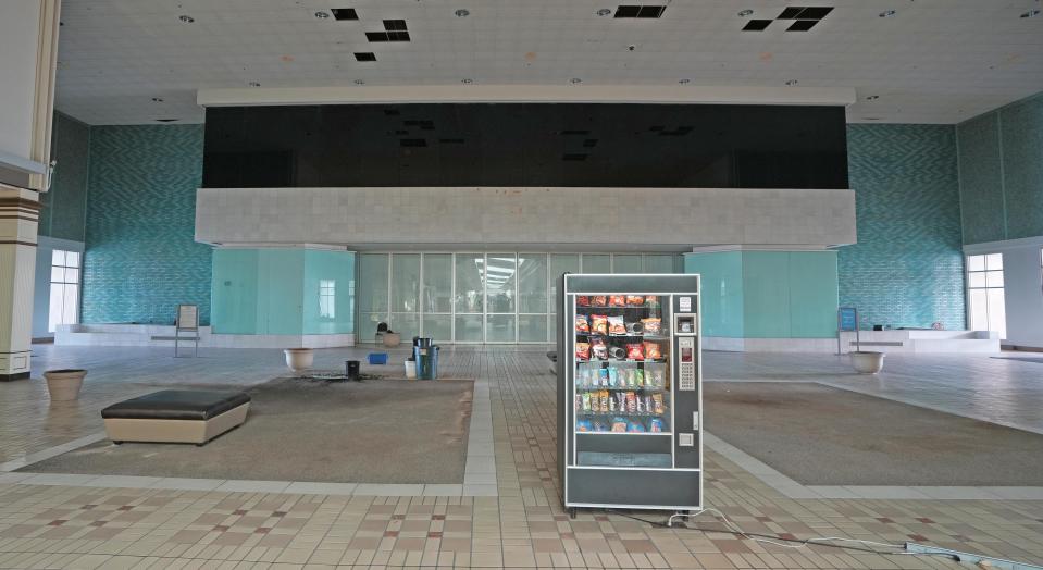 A vending machine still connected to power with an extension cord sits outside the Eastland Mall entrance to Lazarus, which was once Columbus' premier department store. A water line break flooded parts of the iconic Hamilton Road shopping mall, causing it to close Tuesday. But the mall is closing permanently after 54 years in business.