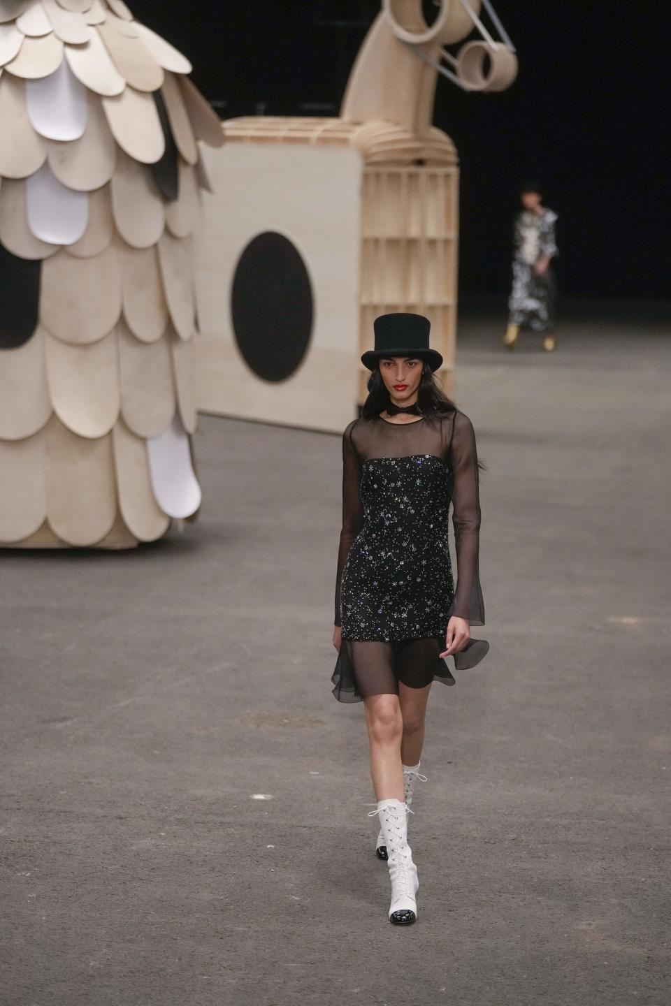 A model wears a creation as part of the Chanel Haute Couture Spring-Summer 2023 collection presented in Paris, Tuesday, Jan. 24, 2023. (AP Photo/Thibault Camus)