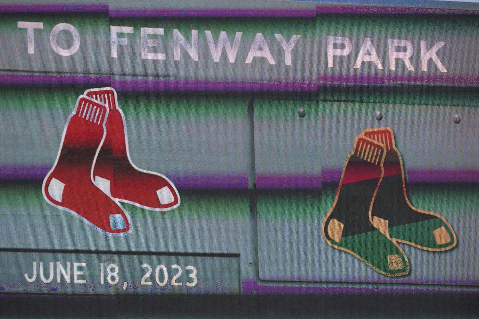 A display on a scoreboard shows a Red Sox emblem, left, next to a Red Sox emblem featuring colors that honor the Juneteenth holiday, right, at Fenway Park before a baseball game between the New York Yankees and the Boston Red Sox, Sunday, June 18, 2023, in Boston. The Red Sox were among the teams marking the June 19 holiday this weekend. (AP Photo/Steven Senne)