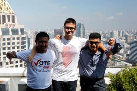 Thai student activists, Than Rittiphan, 24, (R), Rangsiman Rome, 24, (C) and activist Pakorn Areekul, 27, pose for photographs before an interview with Reuters in Bangkok, Thailand July 25, 2016. REUTERS/Chaiwat Subprasom