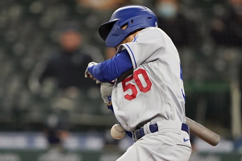 Los Angeles Dodgers' Mookie Betts gets hit by a pitch during the ninth inning of a baseball game.