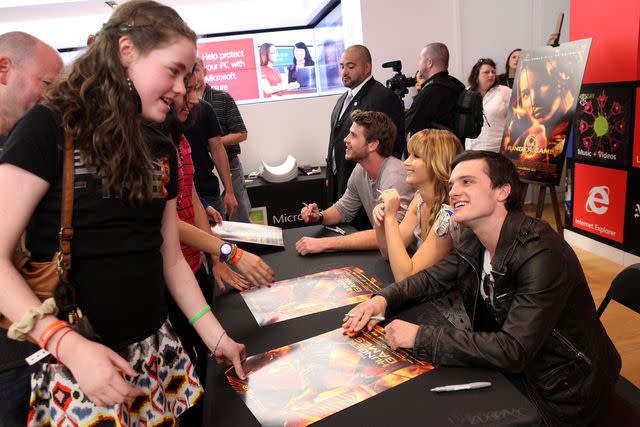 Jesse Grant/Getty Liam Hemsworth, Jennifer Lawrence, and Josh Hutcherson sign autographs for fans at Westfield Century City on March 3, 2012